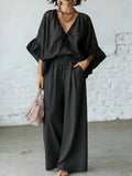 Women's loose-fit V-neck top and wide-leg pants casualwear set by FitiqueFit, featuring a relaxed fit and comfortable fabric.