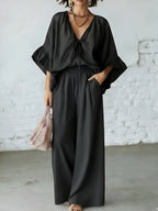 Women's loose-fit V-neck top and wide-leg pants casualwear set by FitiqueFit, featuring a relaxed fit and comfortable fabric.
