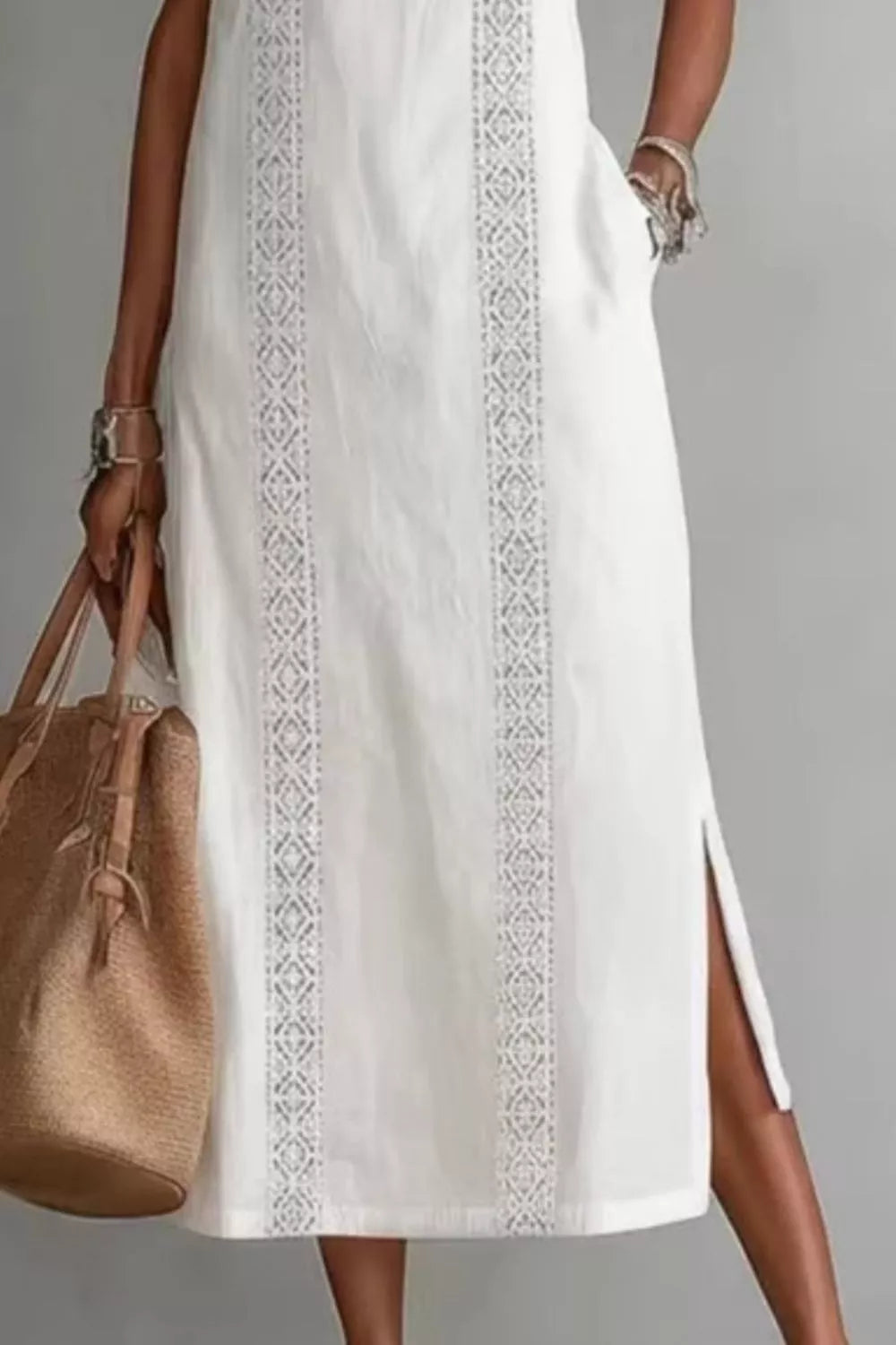 Women's sleeveless maxi dress with side slit and pockets by Plush Fashion Hub, featuring a flowing silhouette and stylish design.
