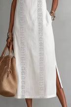 Women's sleeveless maxi dress with side slit and pockets by Plush Fashion Hub, featuring a flowing silhouette and stylish design.