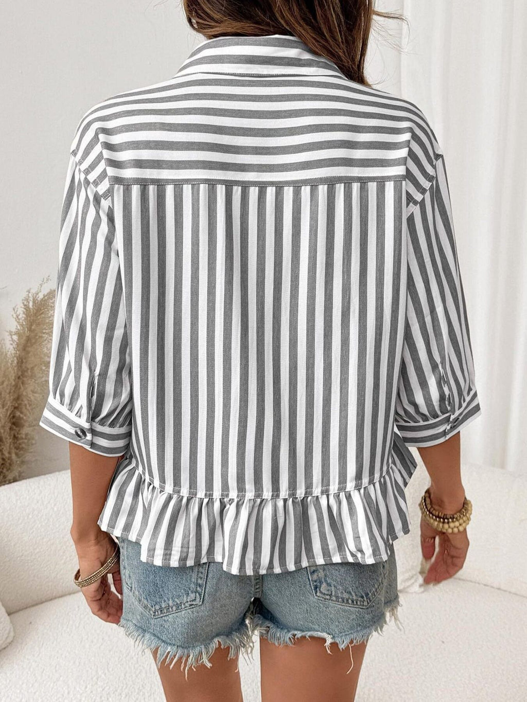 Women's striped button-down blouse with ruffled hem, lightweight viscose fabric, from Trendsi, showing front view.