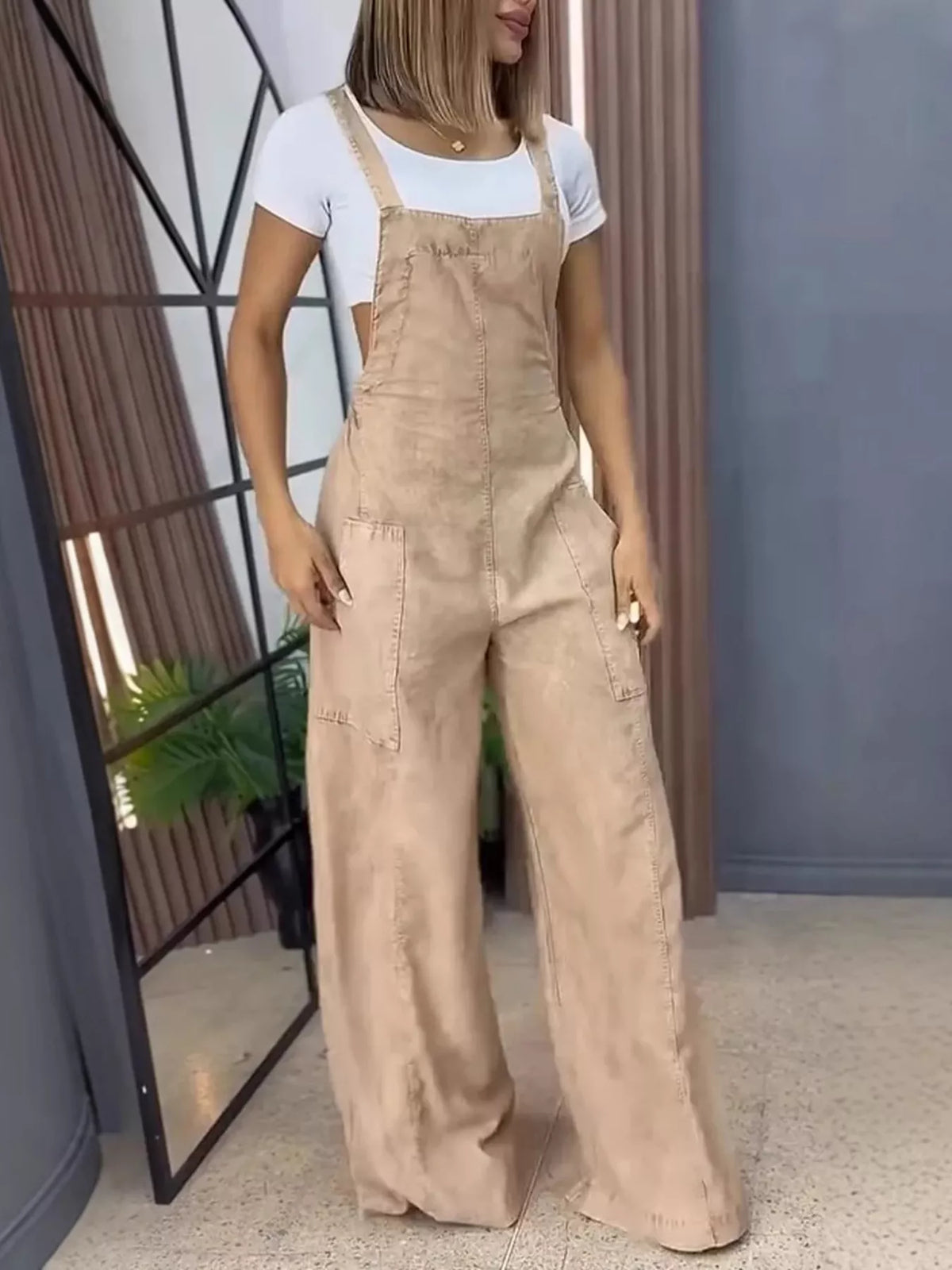 Blue wide leg denim overalls by Plush Fashion Hub, full-size one-piece jumpsuit with relaxed fit and adjustable straps.