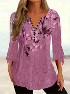 Women’s printed spike button three-quarter sleeve casual top by Plush Fashion Hub, featuring a colorful design and relaxed fit.