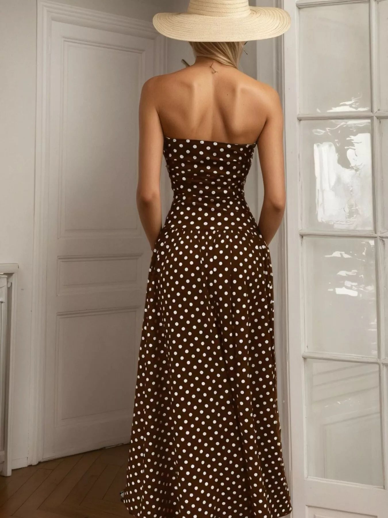 Polka dot strapless maxi dress by Shopimist featuring a flowing silhouette and bold black and white pattern.