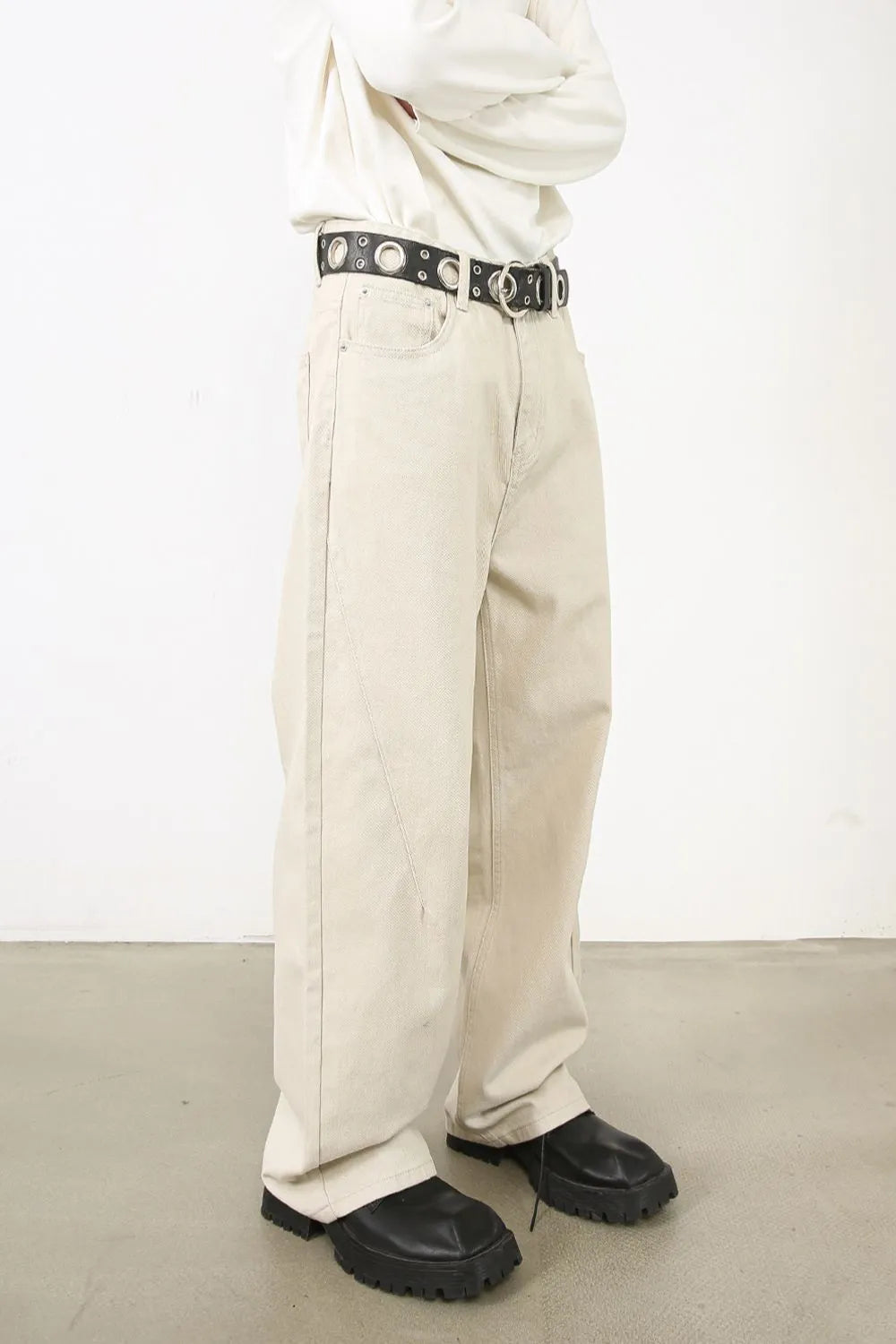 Men's baggy jeans with multiple pockets, trendy denim pants by Trendsi, shown in a relaxed fit style.