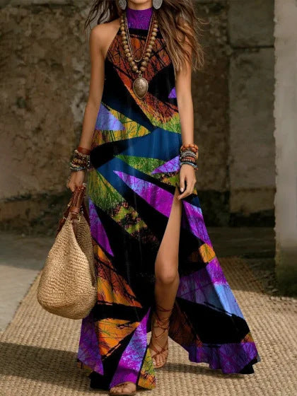 Women's printed halterneck split maxi dress in loose fit with sleeveless design, featuring vibrant patterns and flowing fabric.