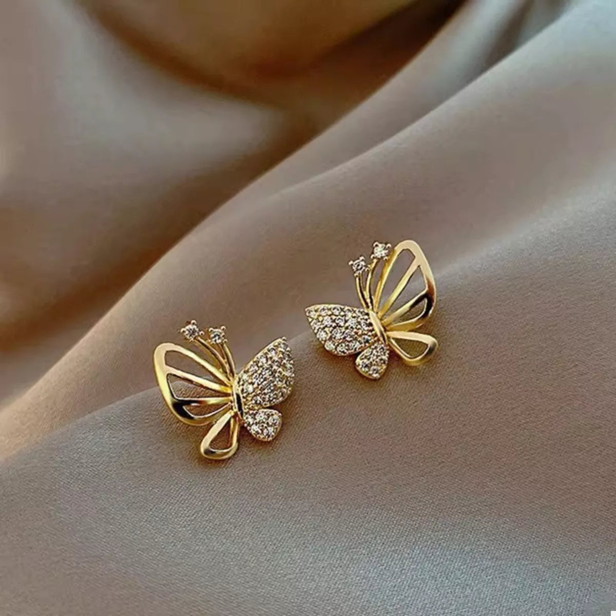 Gold-plated butterfly stud earrings with intricate wing detailing, crafted by Plush Fashion Hub, perfect for adding a delicate touch.