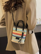 Striped woven mini crossbody bag with adjustable strap, trendy design, and compact size for everyday use.
