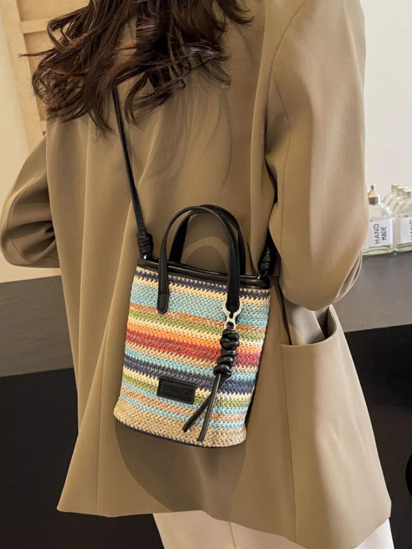 Striped woven mini crossbody bag with adjustable strap, trendy design, and compact size for everyday use.