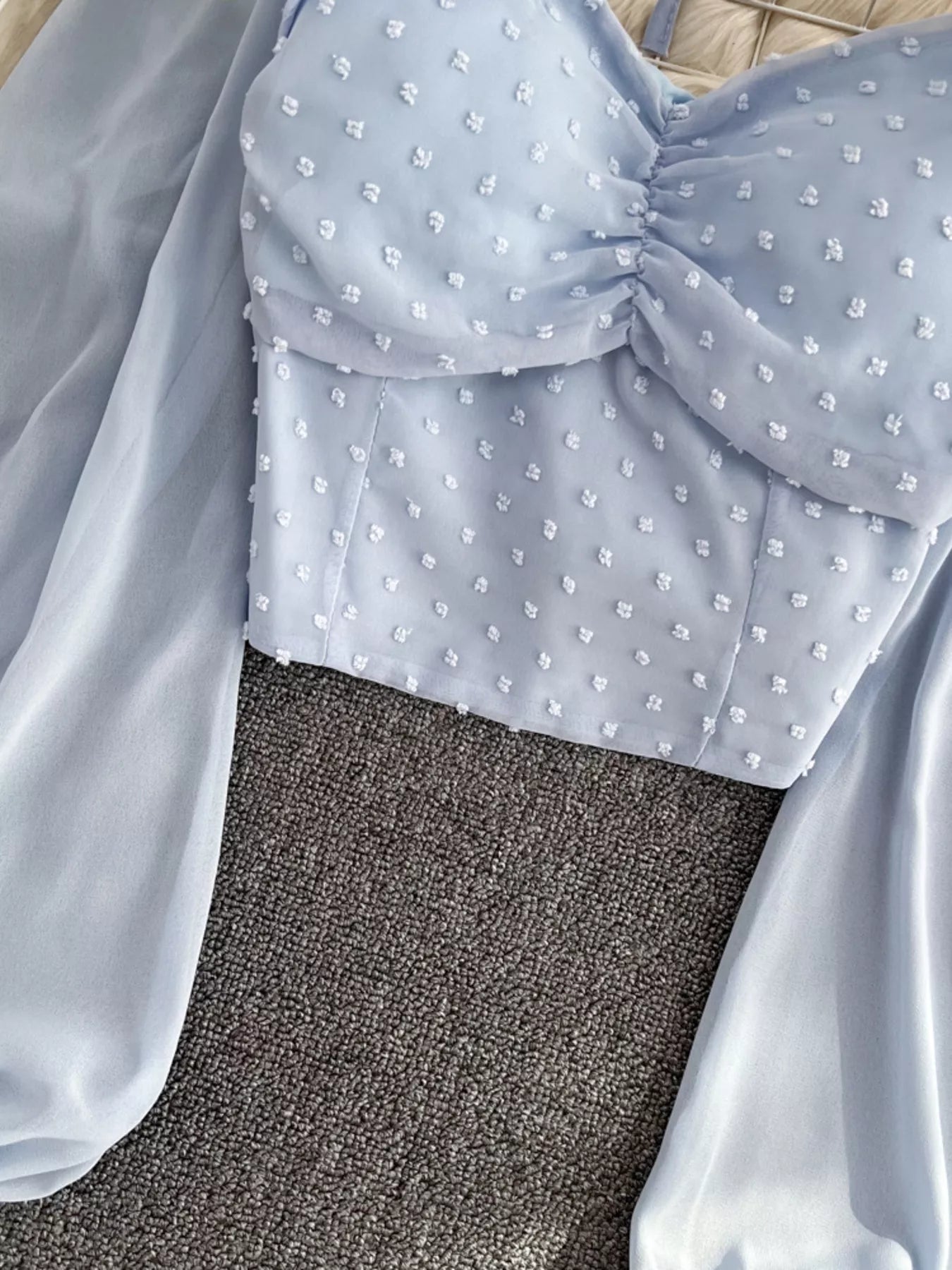 Elegant women's Swiss Dot ruffled flounce sleeve blouse with long sleeves, stylish and feminine top by Trendsi.