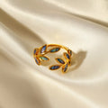 18K gold-plated resin leaf bypass ring with intricate leaf design, showcasing elegant jewelry craftsmanship.