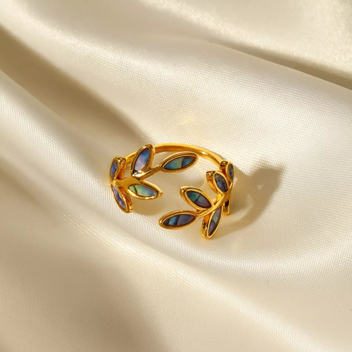 18K gold-plated resin leaf bypass ring with intricate leaf design, showcasing elegant jewelry craftsmanship.