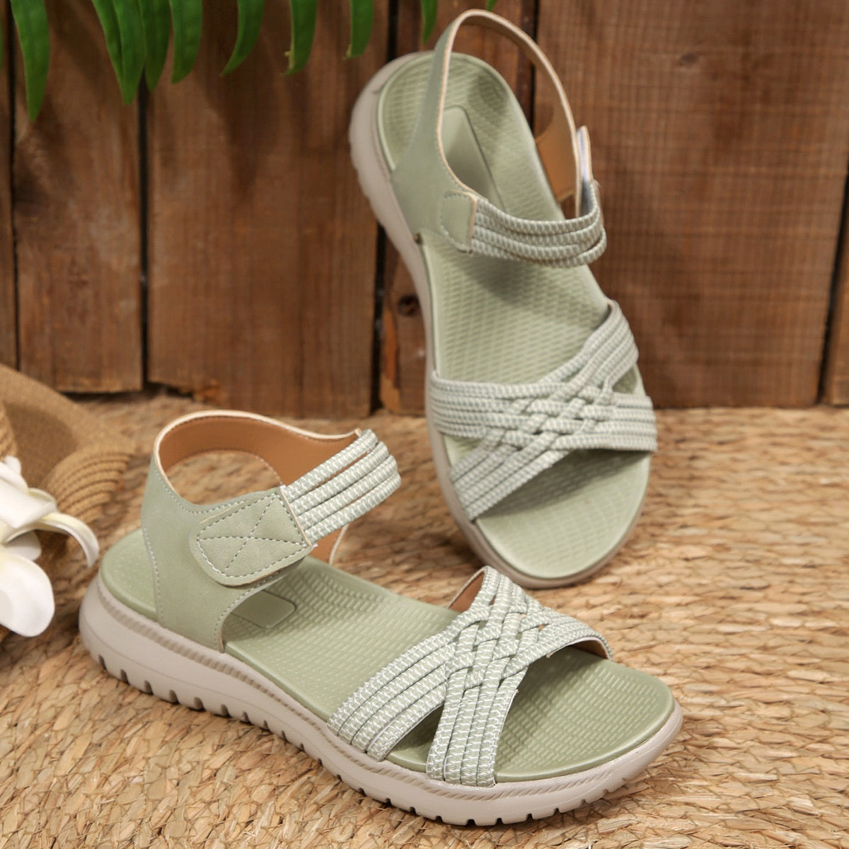 Women's open toe woven strap flat sandals with faux leather slides, featuring comfortable design and casual style.