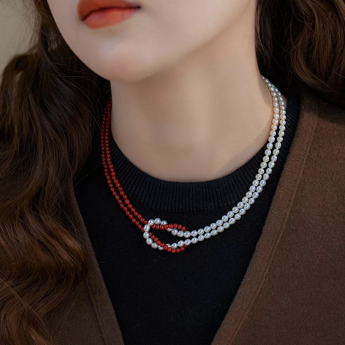Double layered knot necklace by Shopimist featuring intertwined gold-tone chains on a neutral background.
