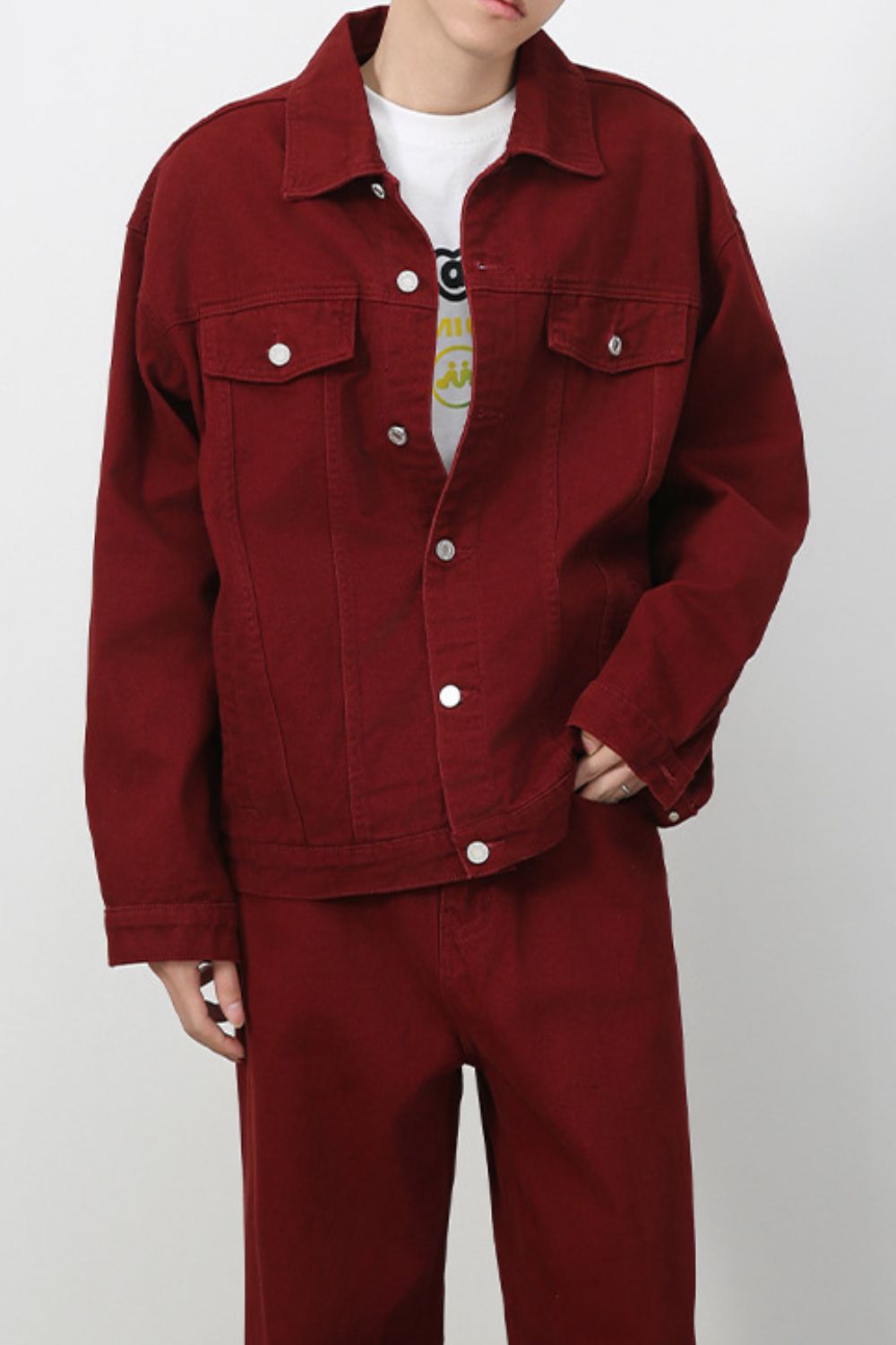 Men's dropped shoulder denim jacket by Plush Fashion Hub, featuring button-up front and casual style, shown on a model.