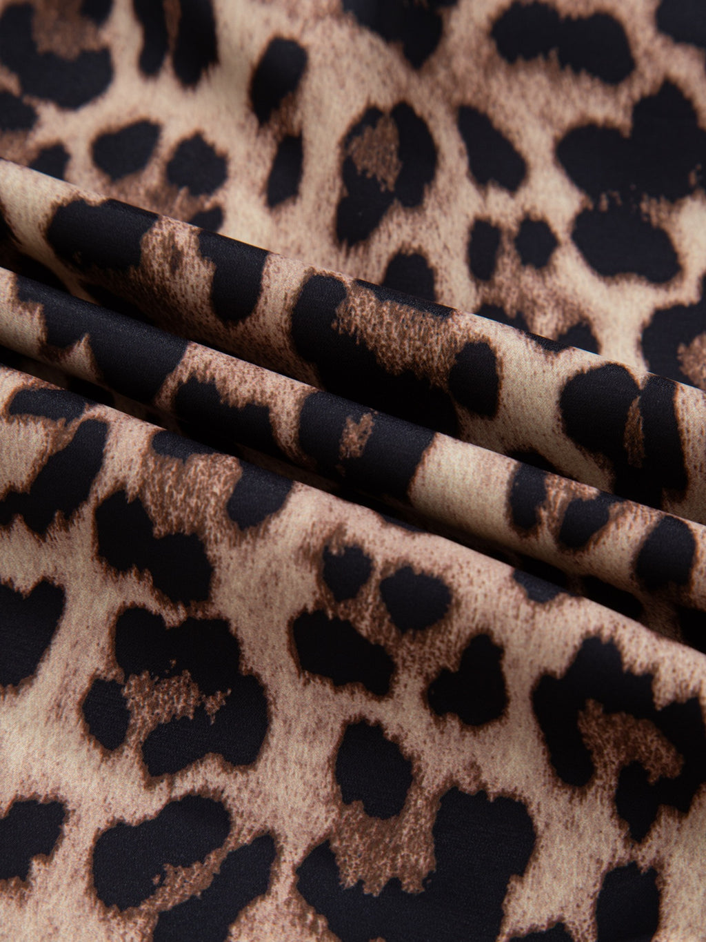 Leopard print short sleeve blouse with lace trim and button front by Plush Fashion Hub, displayed on a hanger.