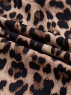 Leopard print short sleeve blouse with lace trim and button front by Plush Fashion Hub, displayed on a hanger.