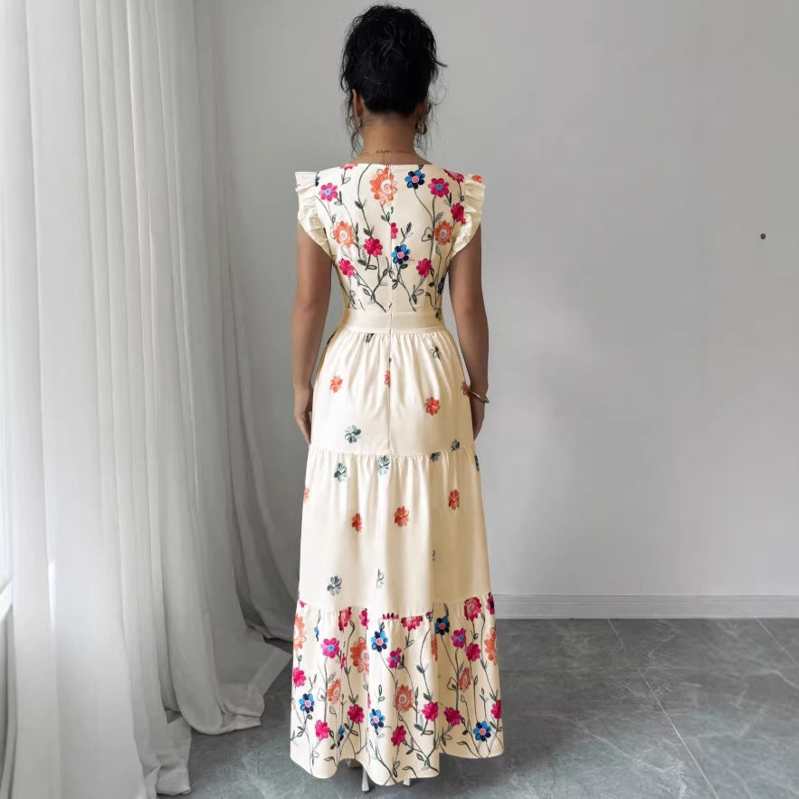 Women’s floral print dress with puff sleeves and waist-cinching design by FitiqueFit, shown on a model.