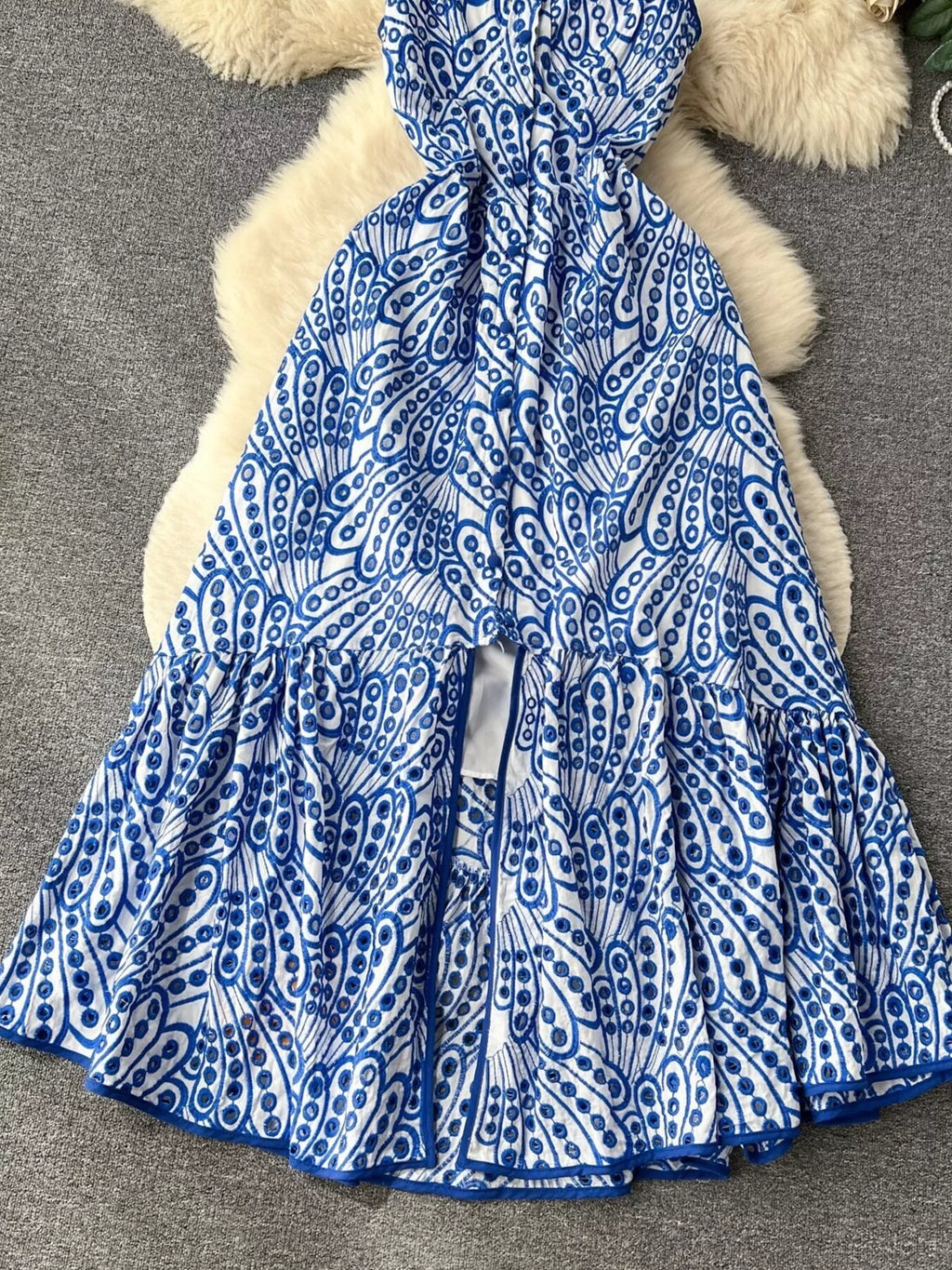 Eyelet embroidered tiered camisole dress by Trendsi, featuring a summer boho midi design with layered fabric and intricate embroidery.