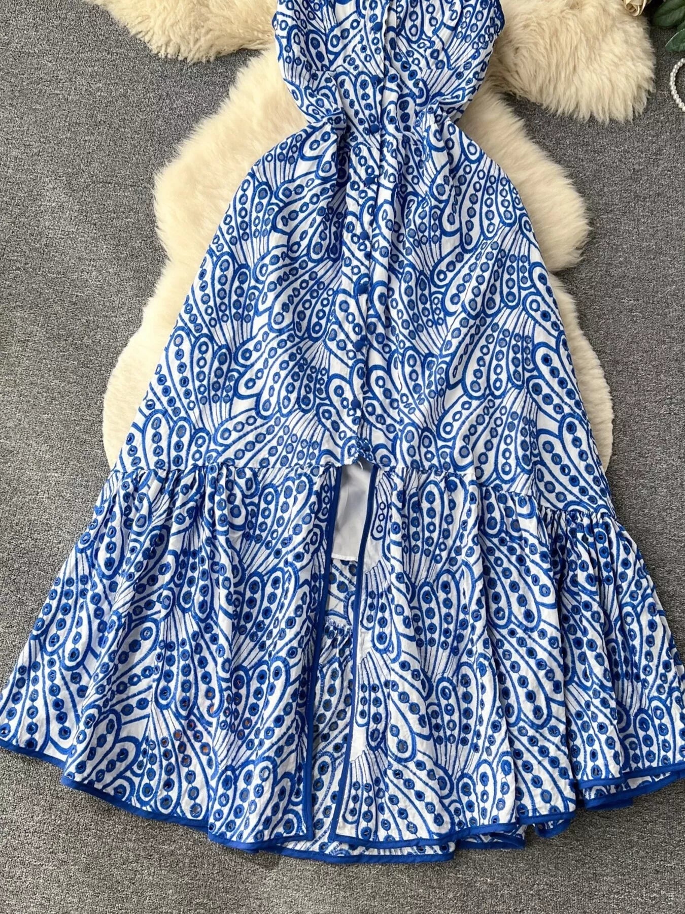 Eyelet embroidered tiered camisole dress by Trendsi, featuring a summer boho midi design with layered fabric and intricate embroidery.