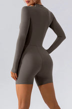 Trendsi half zip long sleeve active romper in black, featuring a fitted design and stretchy fabric for workout or casual wear.