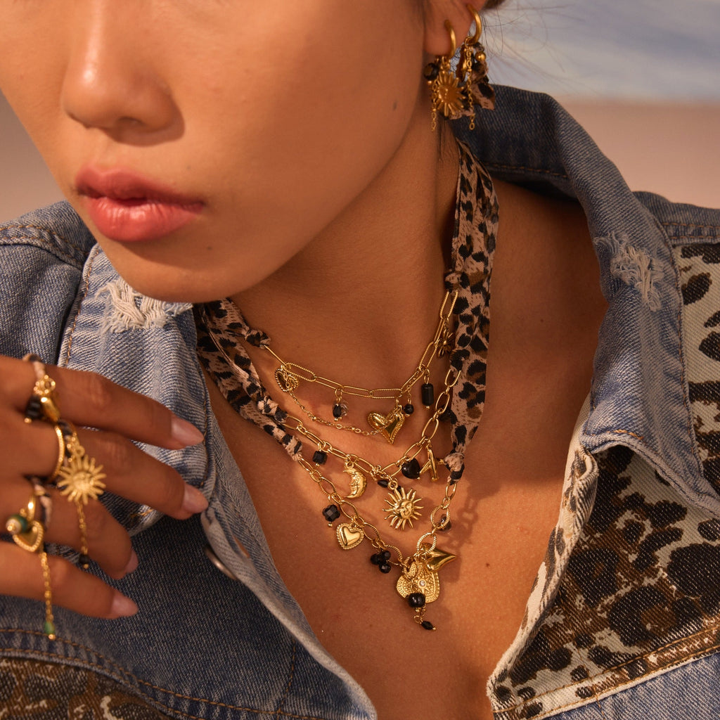 Leopard Series Love Sun pendant in stainless steel with intricate design, hanging as a jewelry ornament.