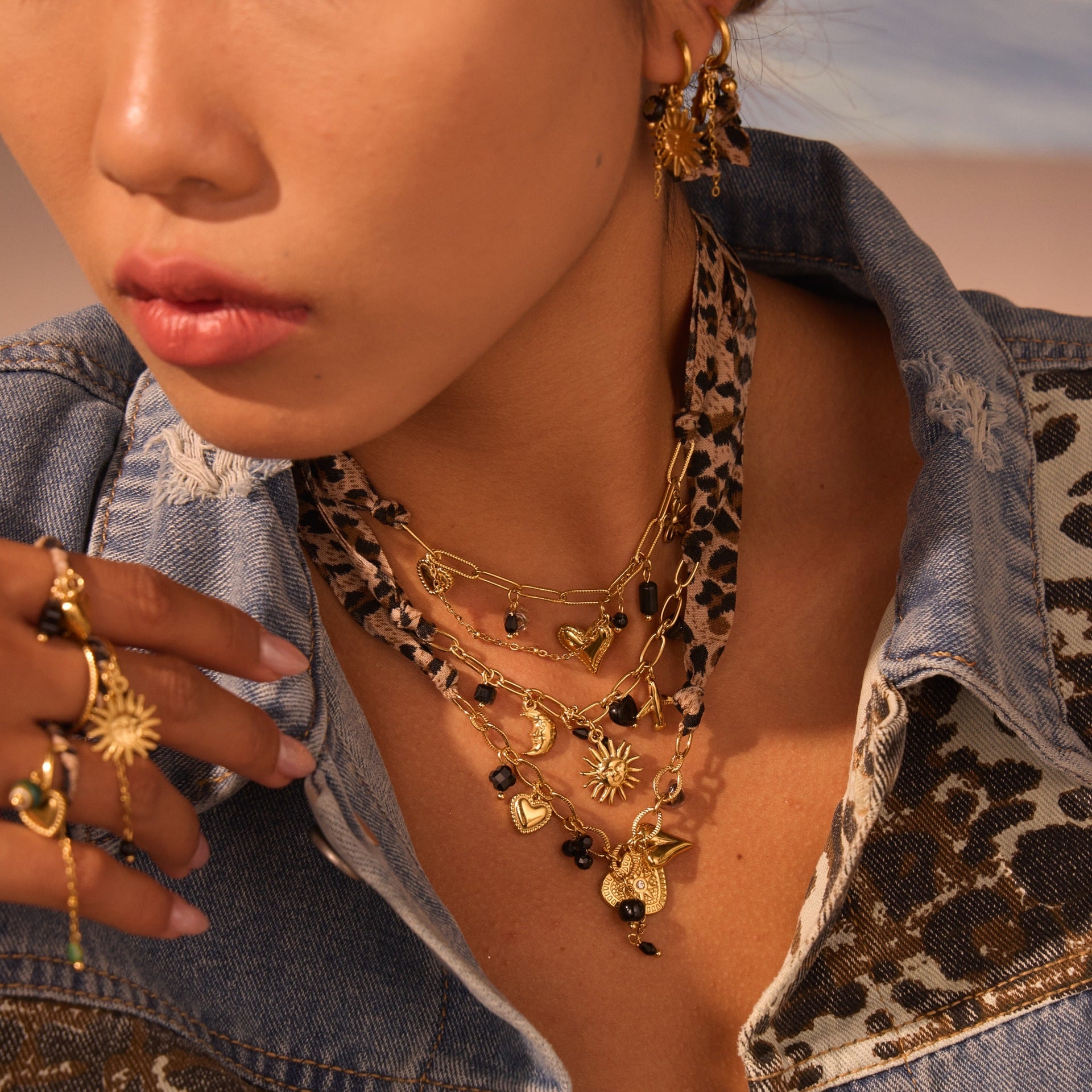 Leopard Series Love Sun pendant in stainless steel with intricate design, hanging as a jewelry ornament.