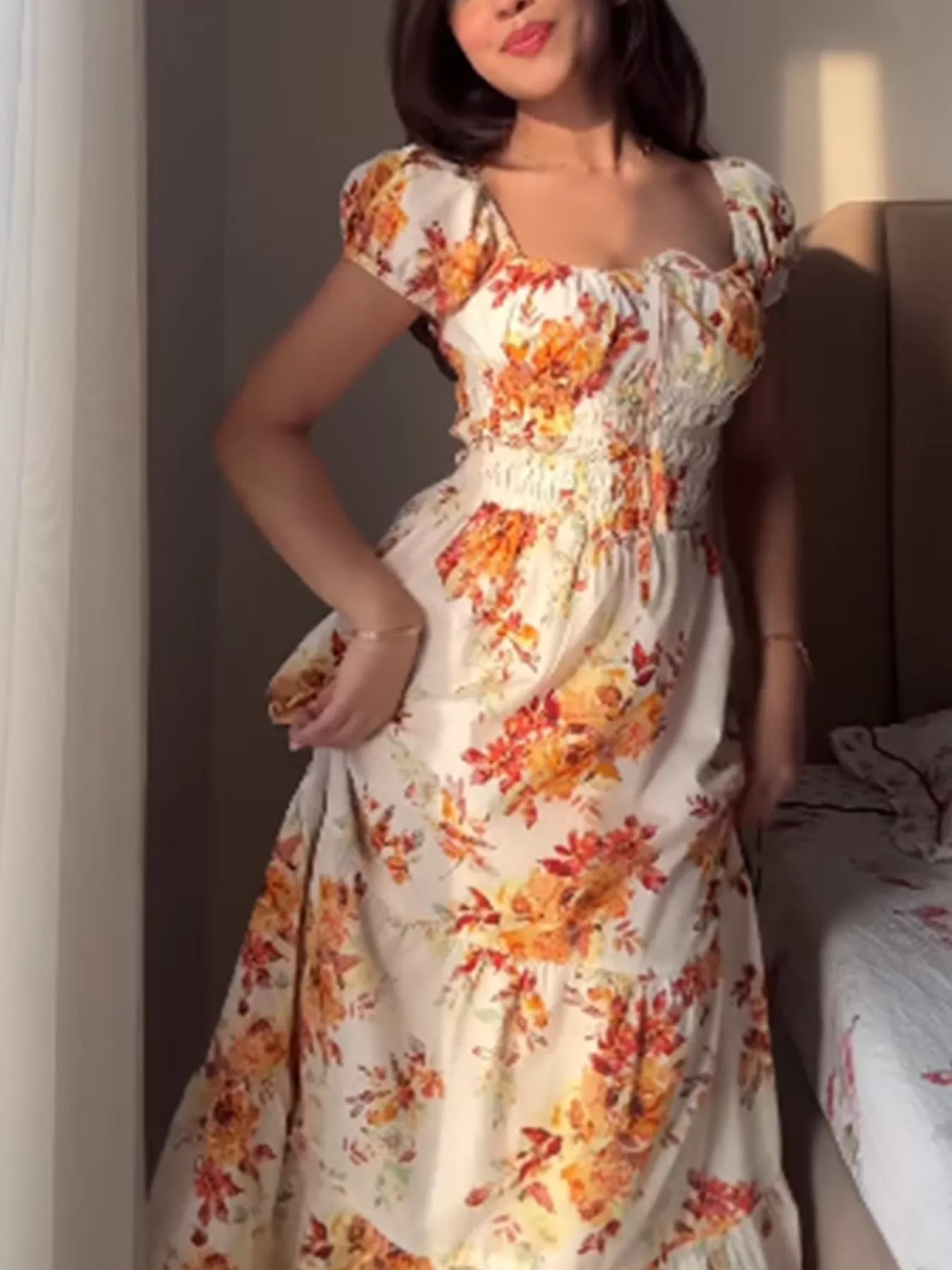 Women's floral print short sleeve ruched maxi dress by Trendsi, featuring a flowing design and vibrant floral pattern.
