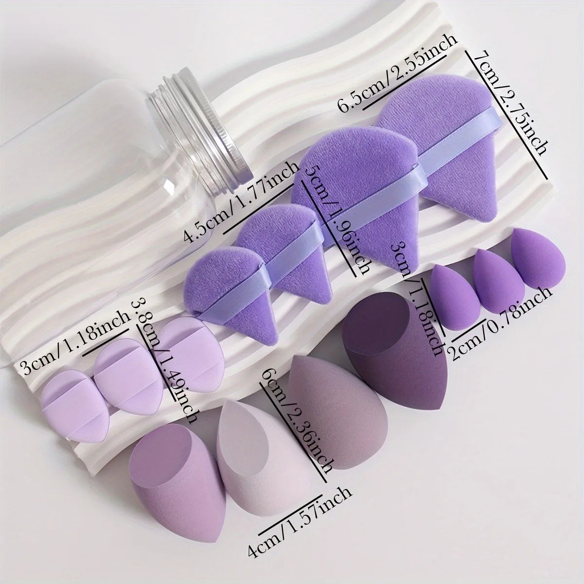 Assorted purple and lavender makeup sponges and powder puffs with size measurements shown.