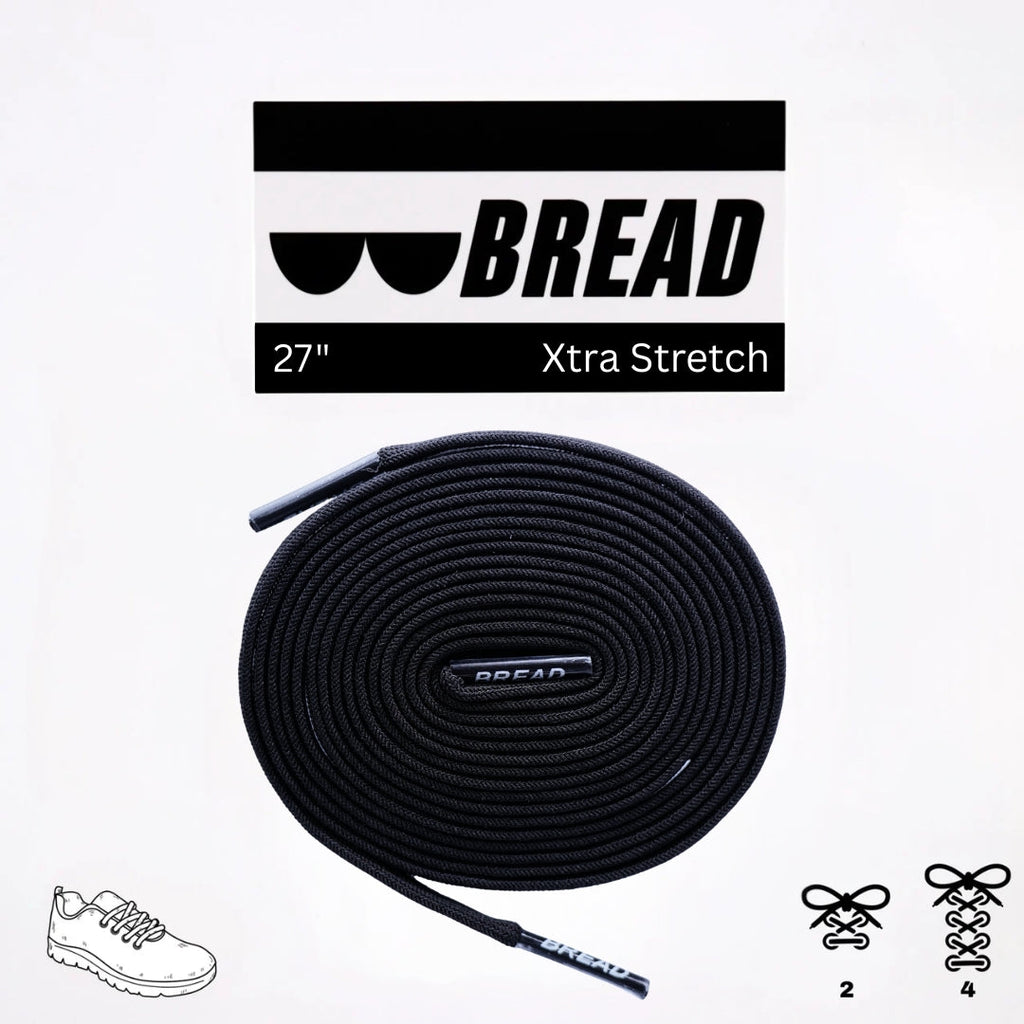 Black elastic shoelace from Plush Fashion Hub labeled Shadow Black, showing its stretchy material and rounded tips.