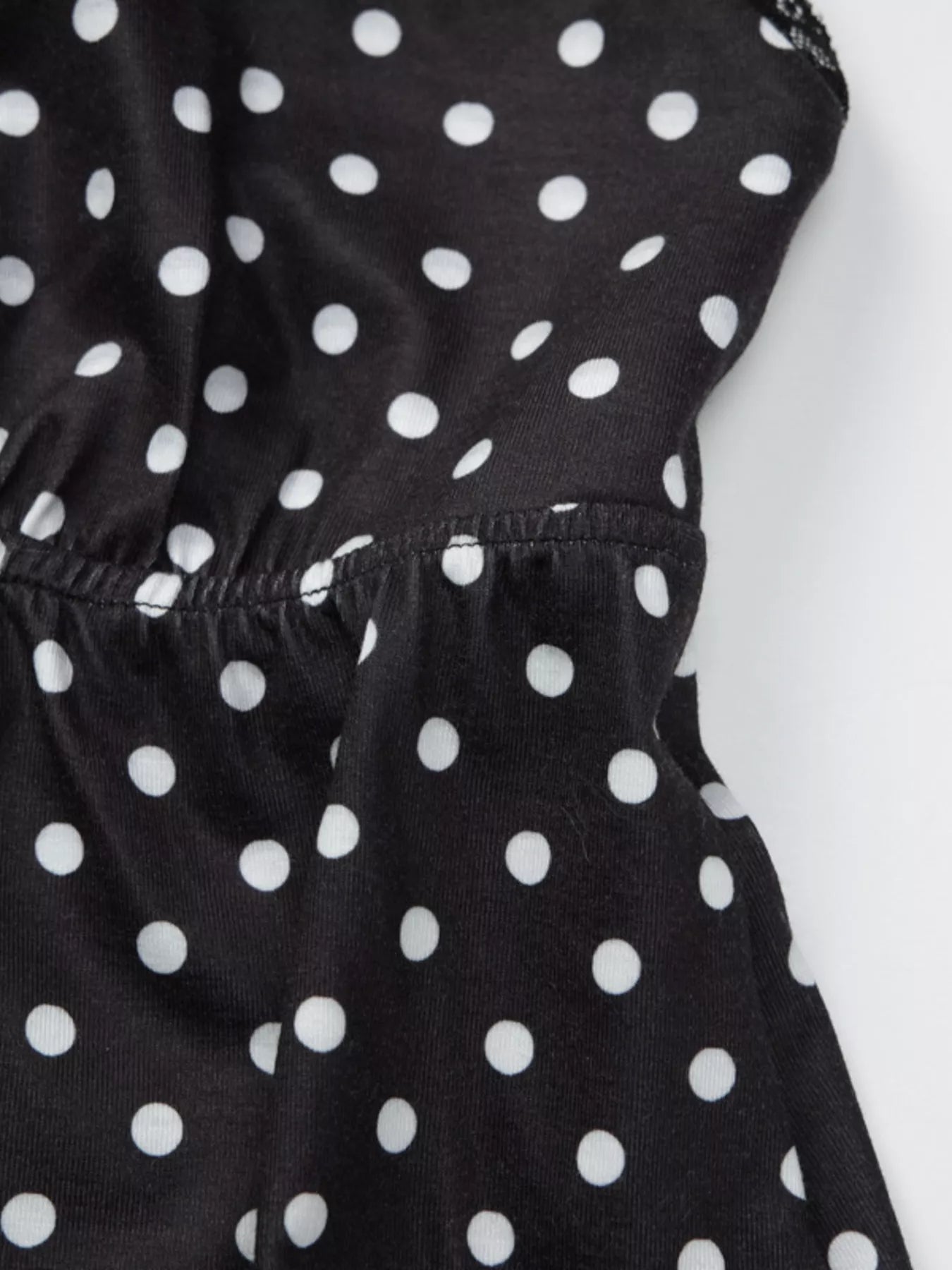Polka dot lace trim cami from Shopimist featuring delicate lace details and a lightweight fabric, ideal for casual or layered looks.
