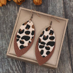 Shopimist leaf shape leather dangle earrings hanging from silver hooks, showcasing a natural leaf design and earthy tones.