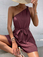 Elegant one-shoulder tie-waist romper in premium polyester, stylish summer jumpsuit by Plush Fashion Hub, shown on a model.
