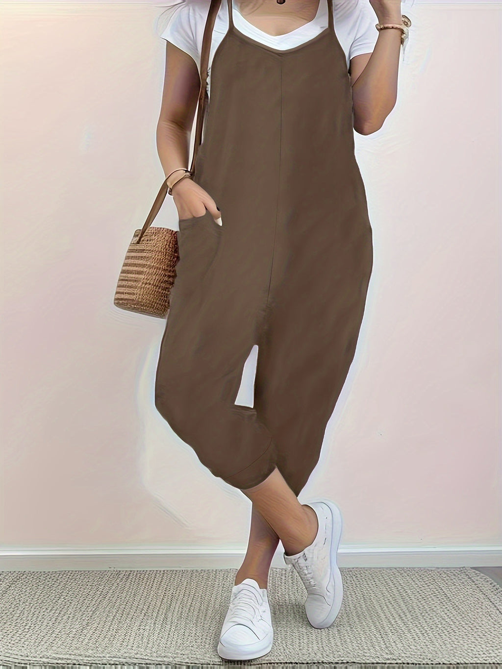 Casual loose fit spaghetti strap jumpsuit with pockets by Trendsi, featuring a relaxed style and lightweight fabric.