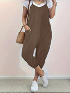 Casual loose fit spaghetti strap jumpsuit with pockets by Trendsi, featuring a relaxed style and lightweight fabric.