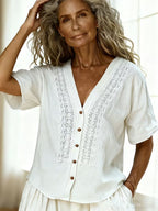 Women's loose-fit faux linen embroidered button-up top by Plush Fashion Hub, showing casualwear with floral embroidery and relaxed fit.