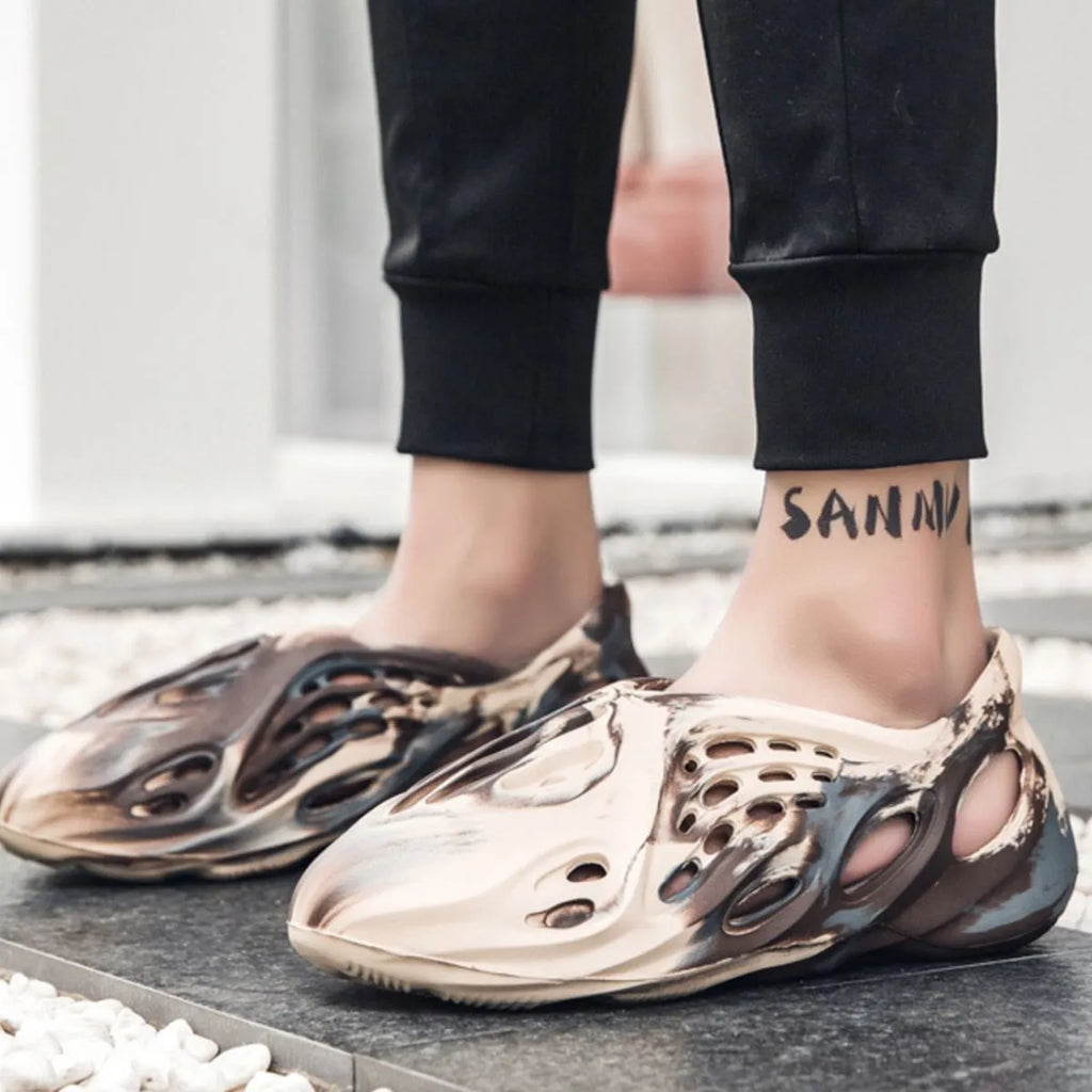 Trendsi hollow-out flat sandals showing open-toe design and stylish cut-out details on beige footwear.