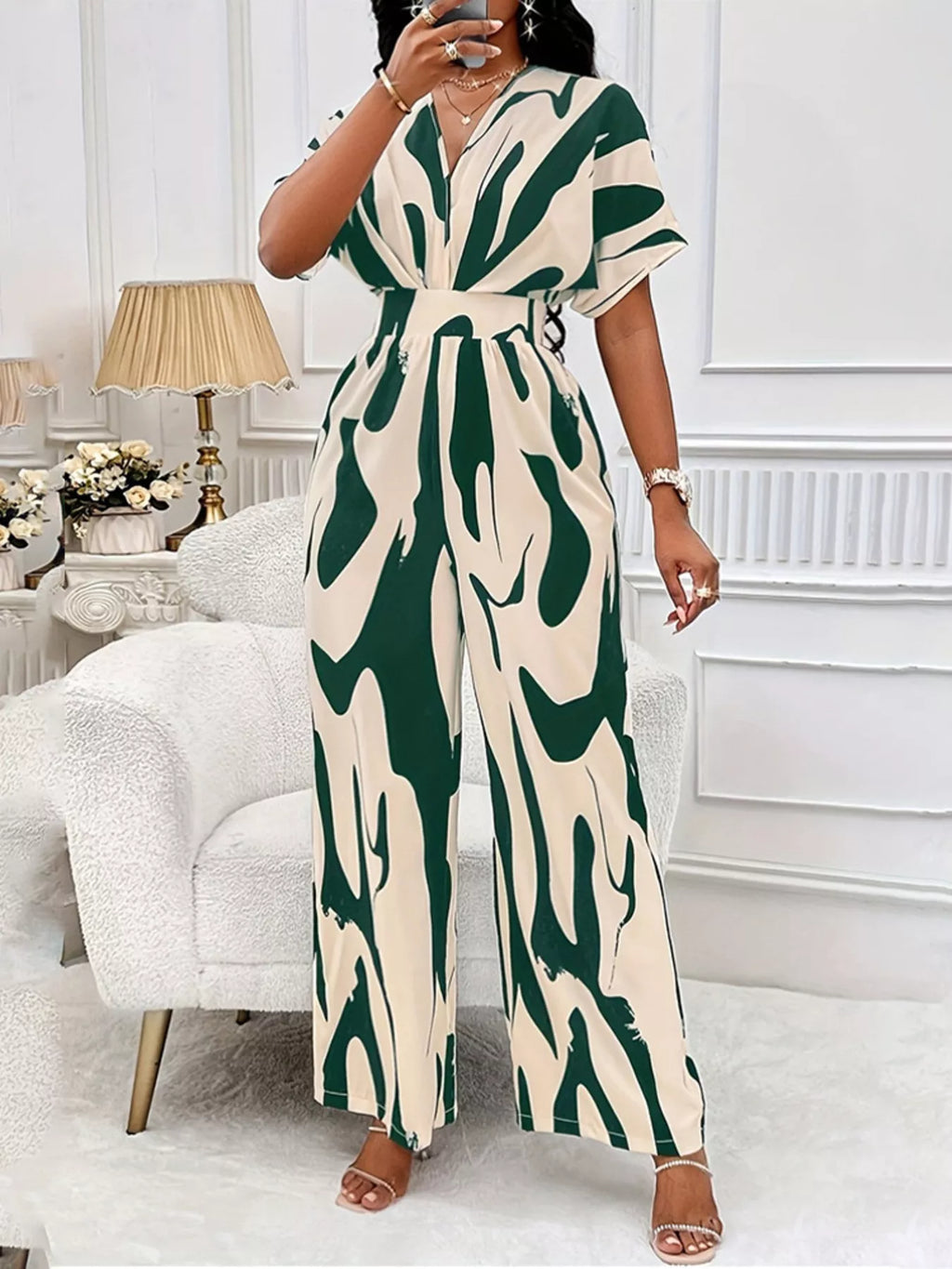Abstract print wide-leg jumpsuit by Trendsi, stylish jumpsuit with flowing wide-leg design and vibrant abstract pattern.