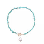 Turquoise irregular pearl necklace from Shopimist, featuring unique uneven pearls on a delicate chain, close-up view.