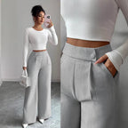 Women's high-waist straight-leg pants by FitiqueFit featuring solid color fabric and button detail, full-length style.