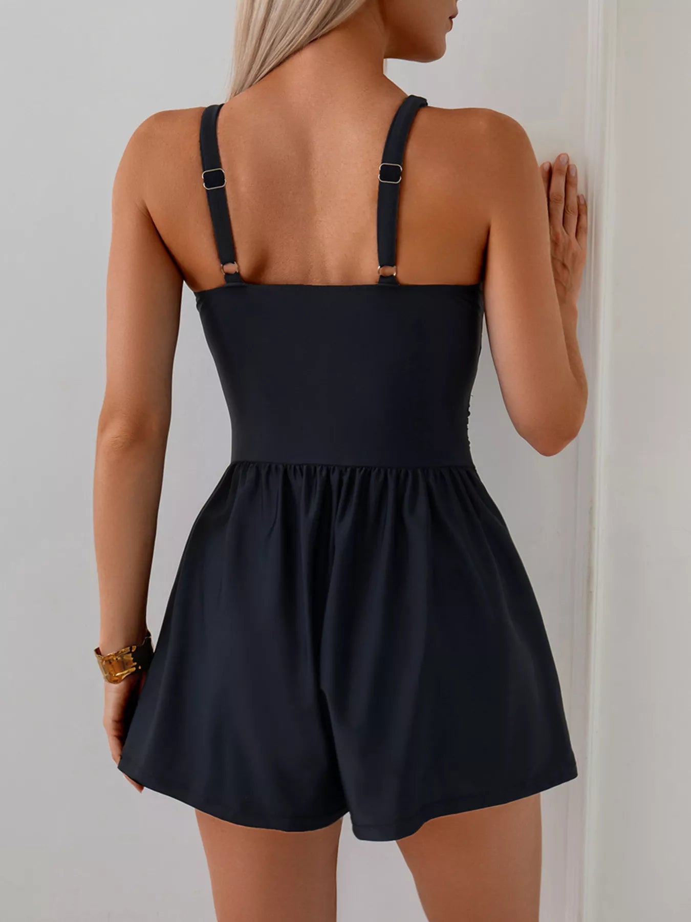 Women's V-neck spaghetti strap one-piece swimsuit by Trendsi, featuring a stretchy, stylish beachwear design.