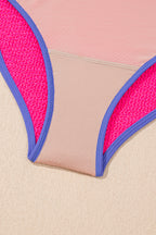 Threaded Pear Rory patchwork one-piece swimsuit with colorful fabric panels, fit for beach or poolside swimming.