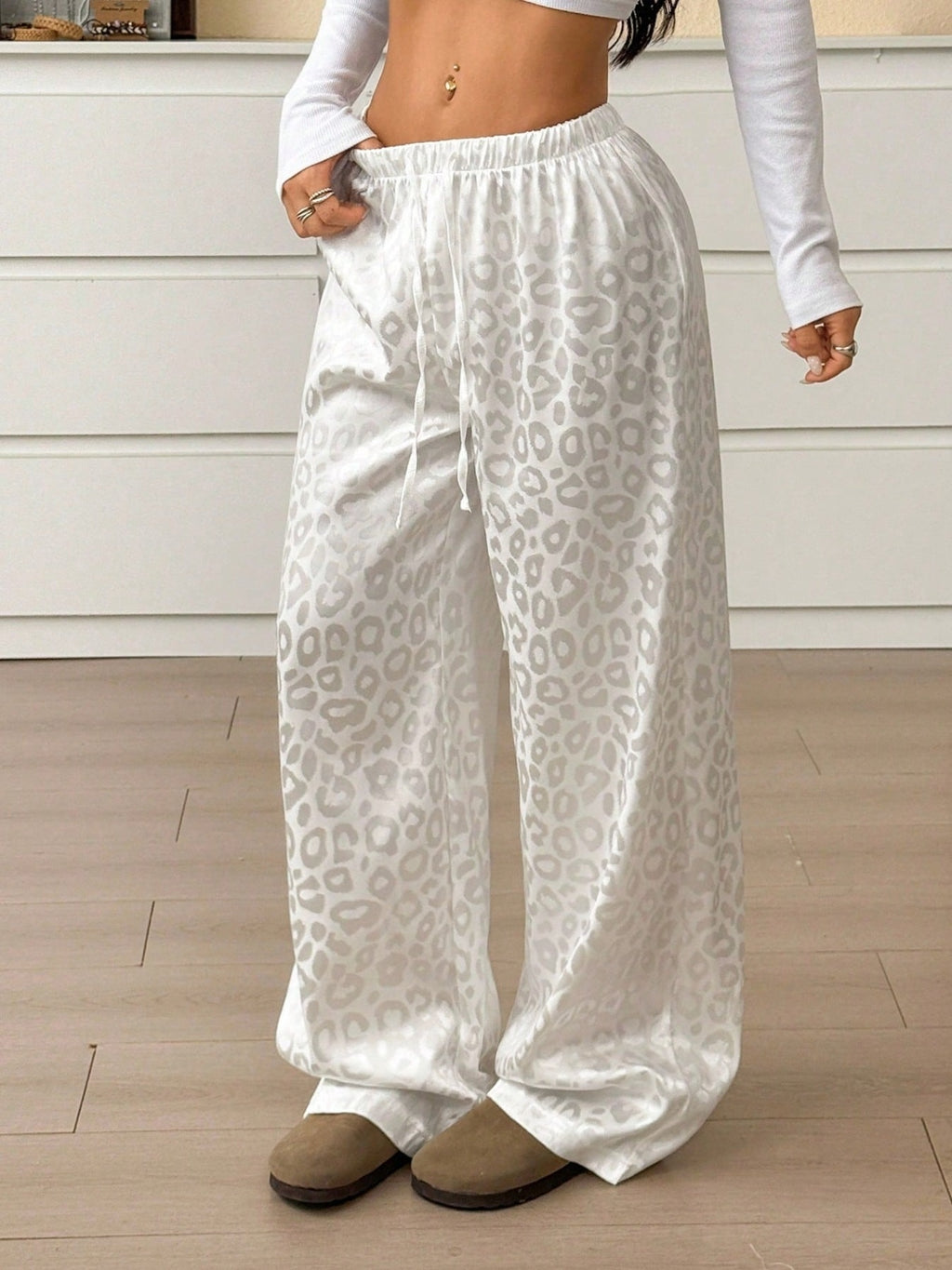 Women's leopard print wide leg trousers with adjustable drawstring waist, stylish and comfortable pants by Trendsi.