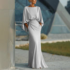 Women's silver backless pleated batwing sleeve maxi dress by FitiqueFit, featuring a mermaid silhouette and elegant flowing design.