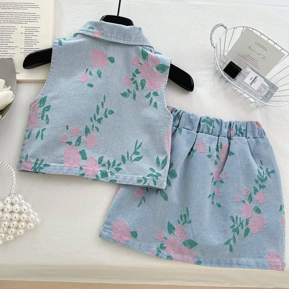 Light blue denim-style vest and skirt set with pink floral and green leaf pattern.