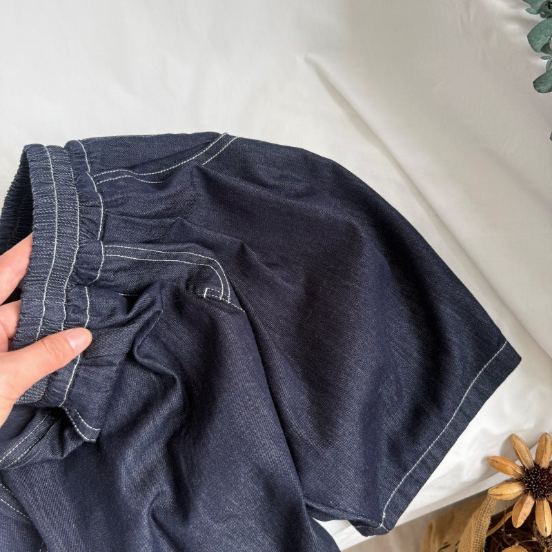 Dark blue denim shorts with an elastic waistband and contrasting white stitching.