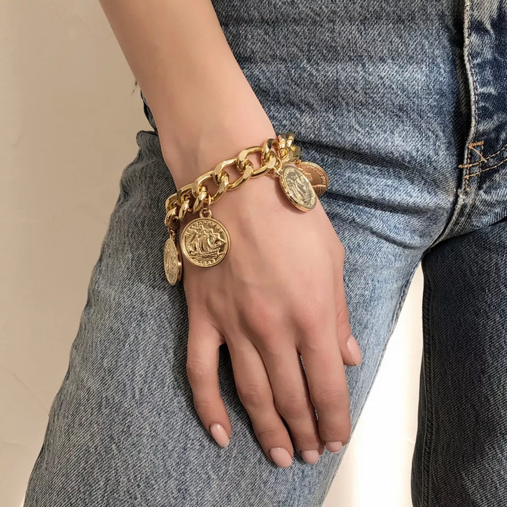 18K gold-plated coin charm bracelet with multiple round coins and delicate chain, showcasing elegant jewelry design.
