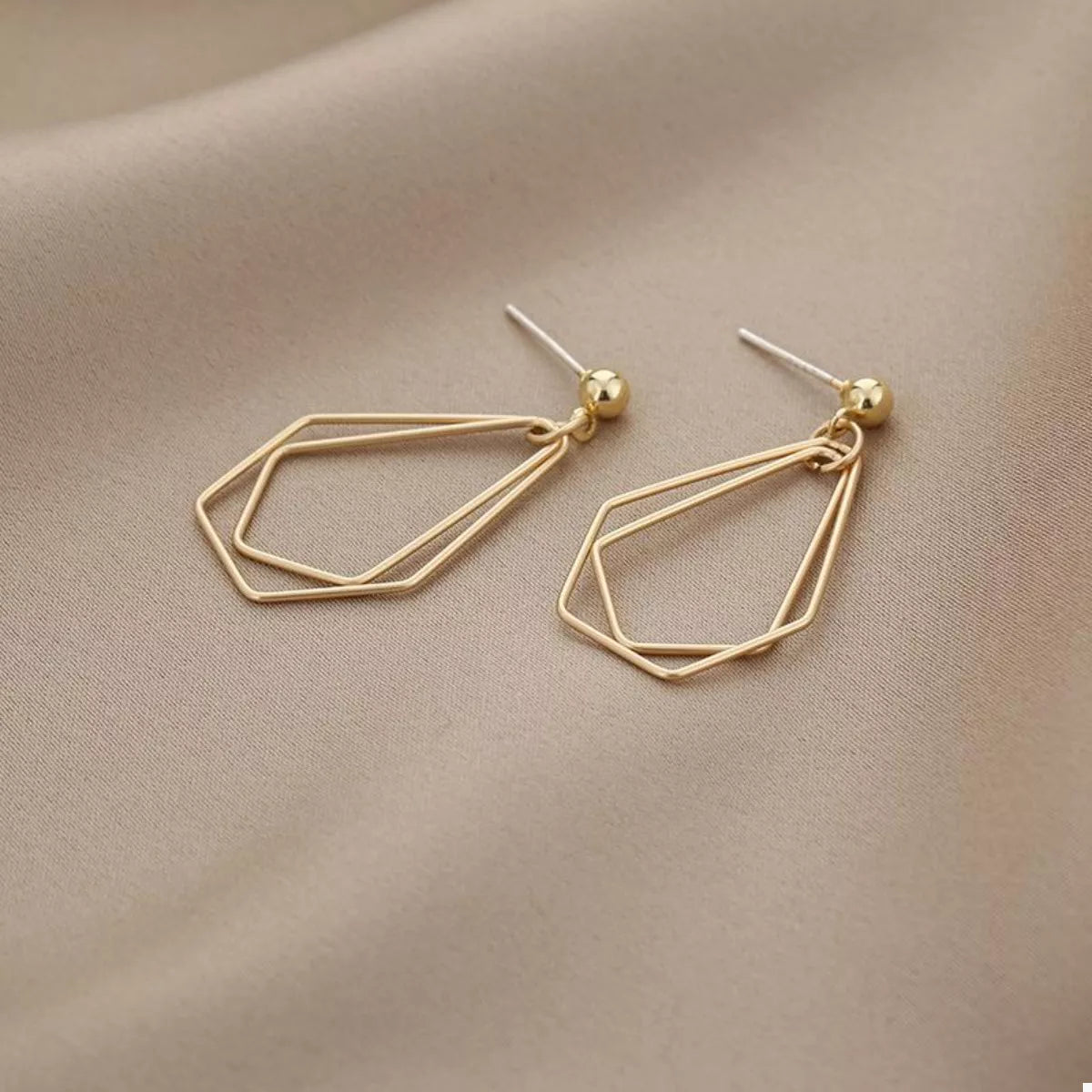 Gold-plated alloy geometric wire drop earrings with modern design, featuring sleek lines and minimalist style.