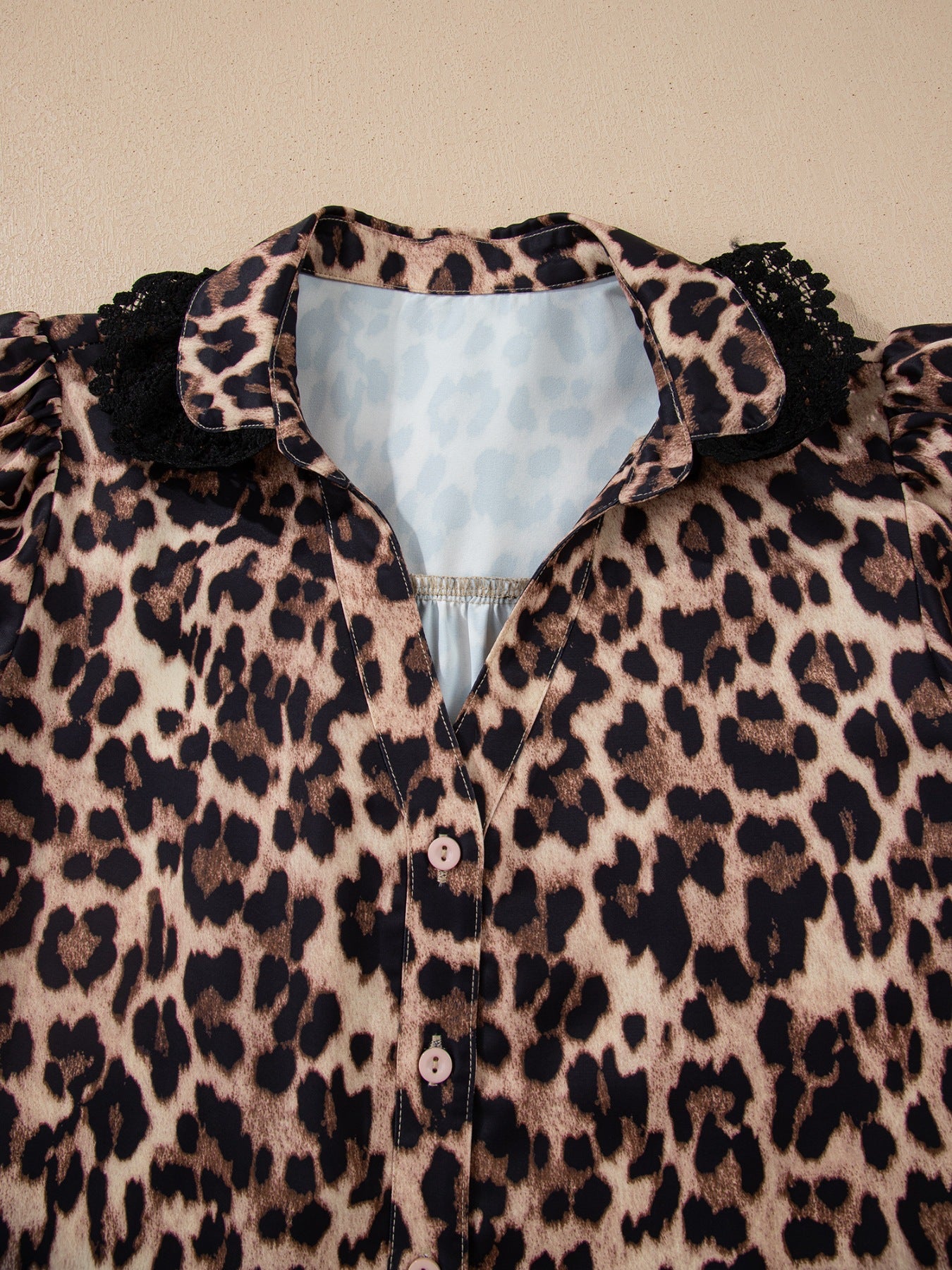 Leopard print short sleeve blouse by Plush Fashion Hub with lace trim and button front, stylish women's tops.