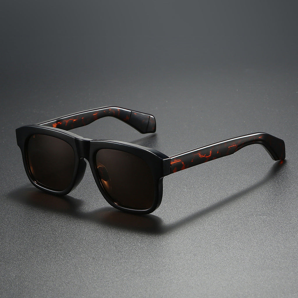 Unisex acetate-style polarized fashion sunglasses with luxury look, featuring dark tinted lenses and stylish frame design.